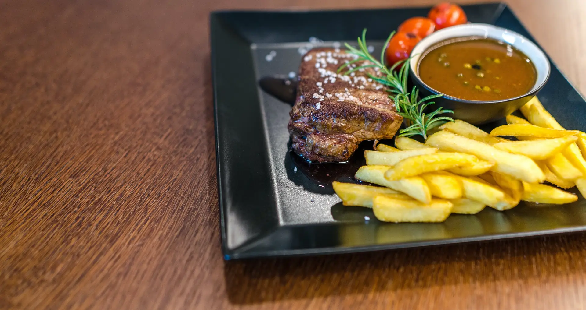 An image of steak and fries